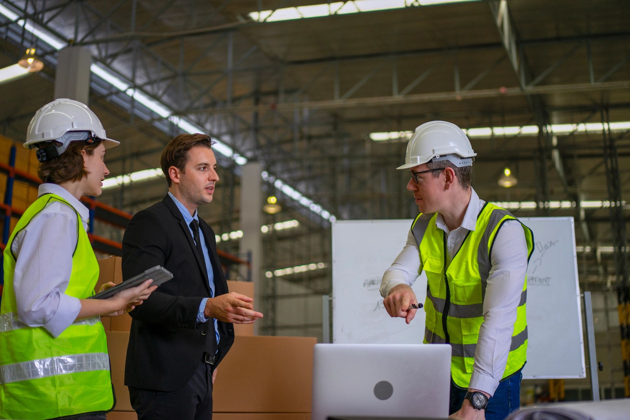 Blue collar workers meeting in warehouse